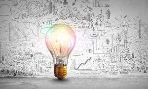 business growth strategy concept - lightbulb in front of a board full of ideas